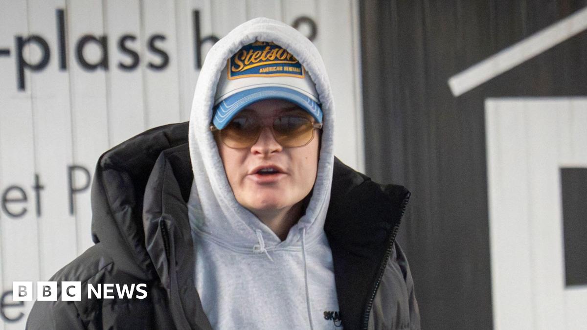 A sketch shows a young man in white and glasses flanked by two people in darker clothing