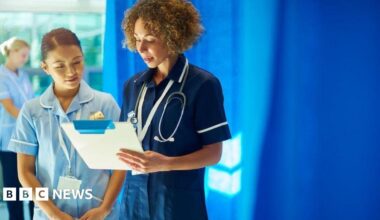 Nurses on a ward, checking patient notes