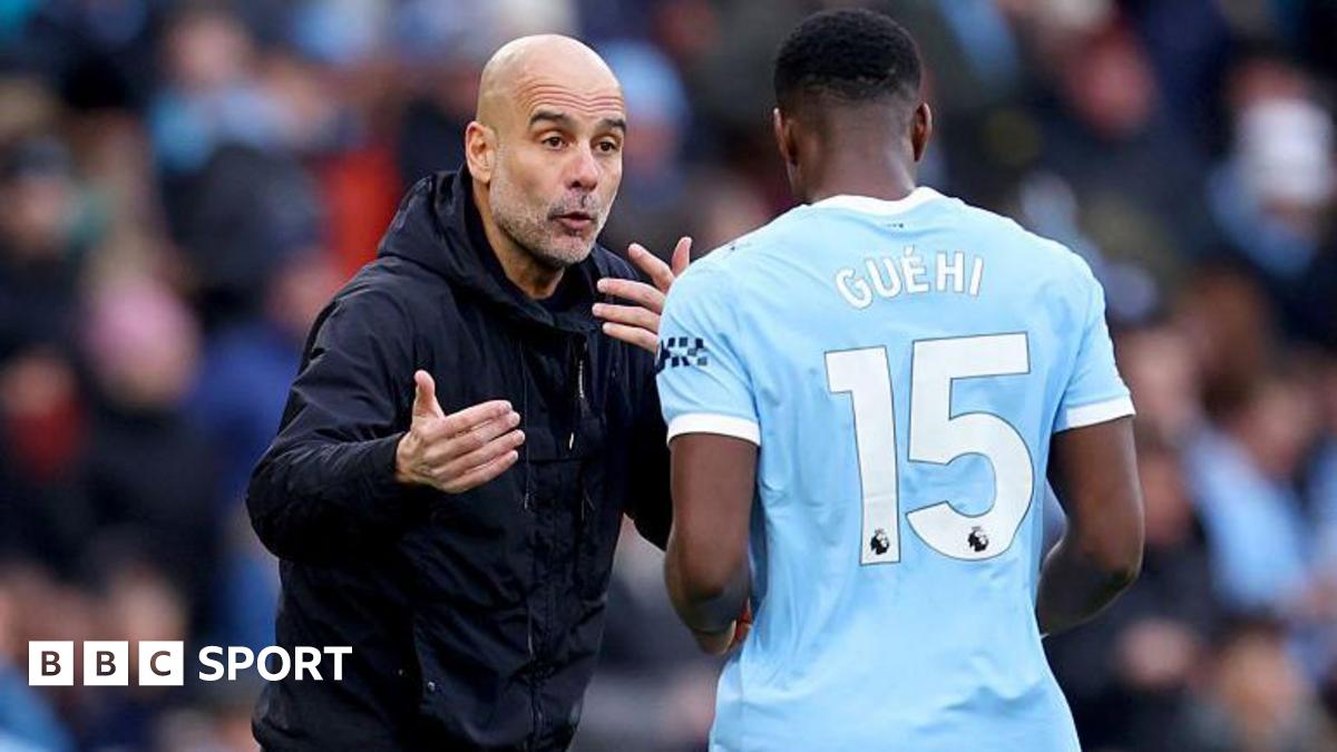 Pep Guardiola, manager of Manchester City, speaks with Marc Guehi on the touchline