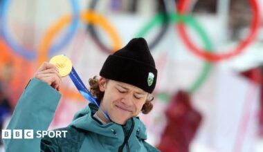 Lucas Pinheiro Braathen holds up his Olympic gold medal