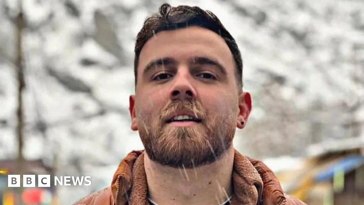 An undated image of Erfan Soltani. He looks at the camera with a slight smile as rain or snow appears to fall.