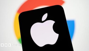 Apple's logo on a smartphone screen, against a blurred background of Google's logo.