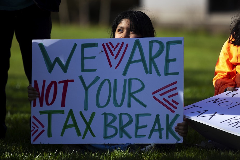 caption: Melanie Gutierrez, 8, of Hoquiam, holds a sign that reads ‘we are not your tax breaks’ during a rally on Thursday, February 26, 2026, at the Washington State Capitol campus in Olympia.