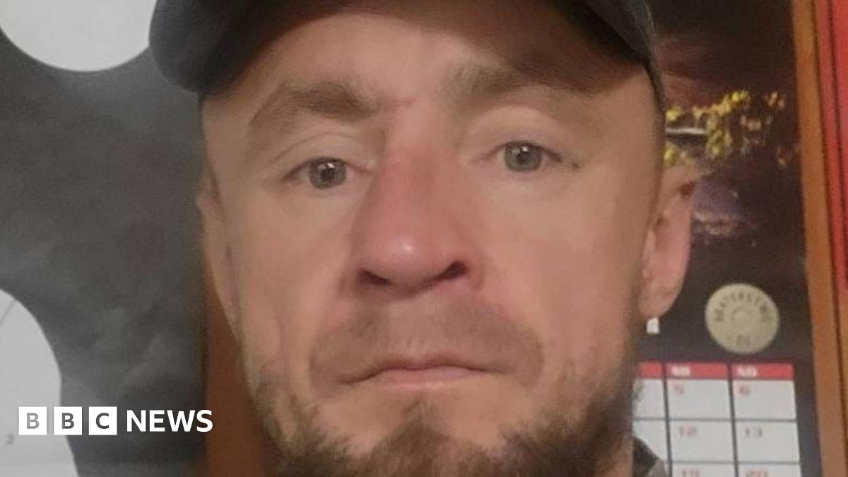 Piotr Pruszak has a light brown beard and wears a cap.