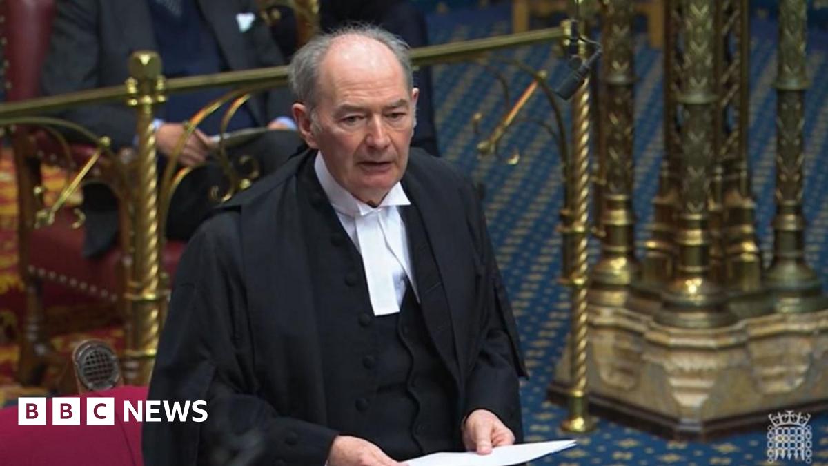Lord Forsyth dressed in a black cloak and white shirt. He is holding a piece of paper as he addresses the House of Lords.