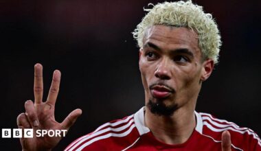 Hugo Ekitike gestures the score to Newcastle fans at Anfield