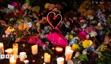 A map showing the small town of Tumbler Ridge as a satellite aerial shot. The location of the secondary school is marked on the map as well as the home where the suspect's family members were found. In the bottom left hand corner there is a map of Canada and the US with a mark showing Tumbler Ridge is in western Canada.