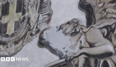 The fresco, which is mostly shades of grey and brown, shows two angels, with one of them crudely scrubbed out