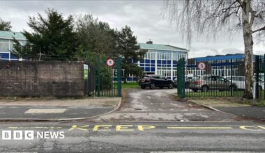 A school building next to a road.