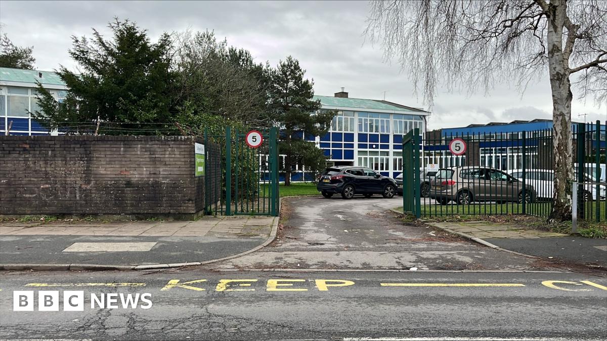 A school building next to a road.