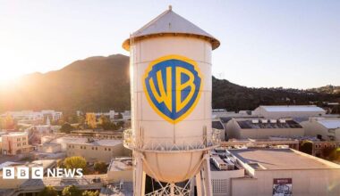 The Warner Bros logo is displayed on the water tower