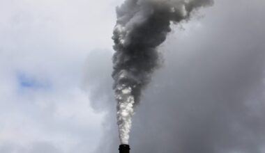 Exhaust rises from the East Bend Generating Station along the Ohio River in Union