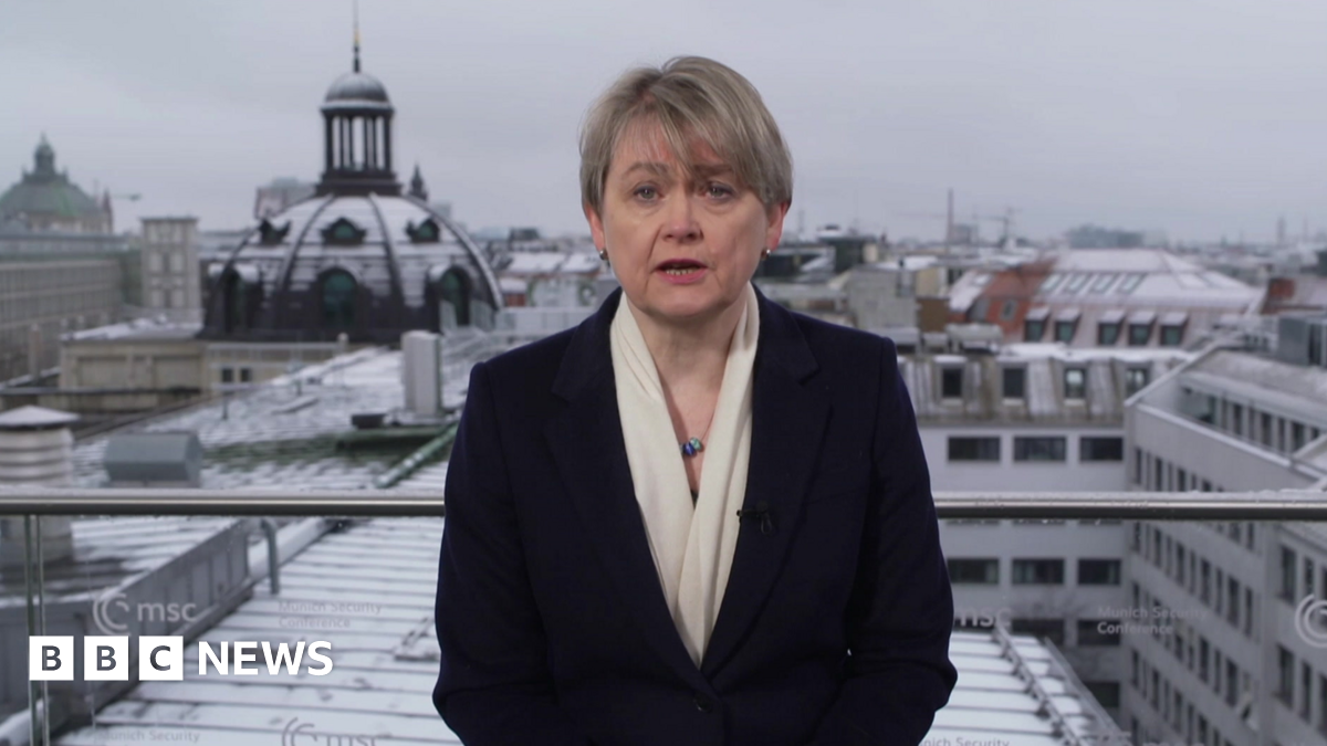 A portrait of late Russian opposition leader Alexei Navalny sits among floral tributes and a candle outside the Russian embassy in Berlin
