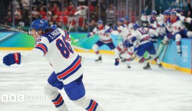 USA players celebrate winning the men's gold medal ice hockey match between Canada and USA