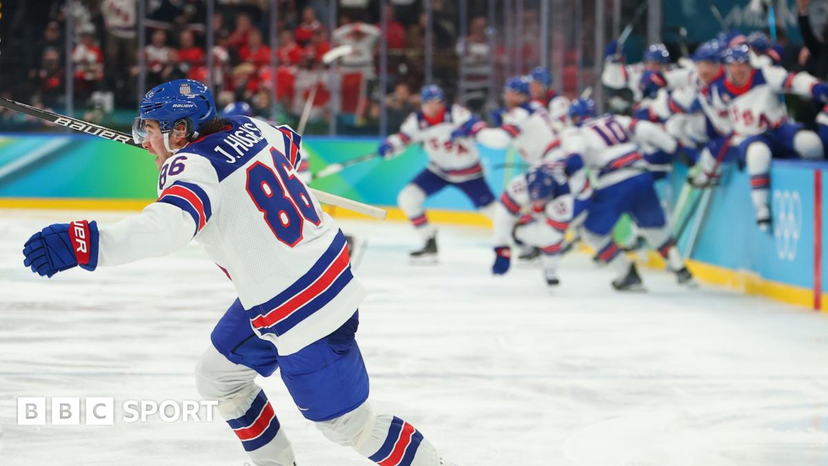 USA players celebrate winning the men's gold medal ice hockey match between Canada and USA