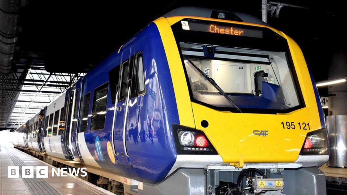 An image of a blue-and-yellow train standing at a platform. Chester is showing as the train's destination on a digital display above the driver's compartment.