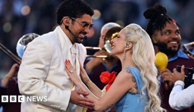 Picture of Bad Bunny in a cream suit surrounded by dancers in white
