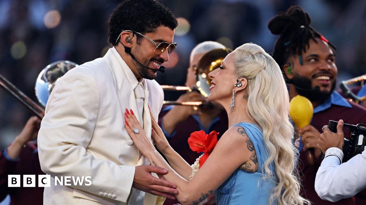Picture of Bad Bunny in a cream suit surrounded by dancers in white