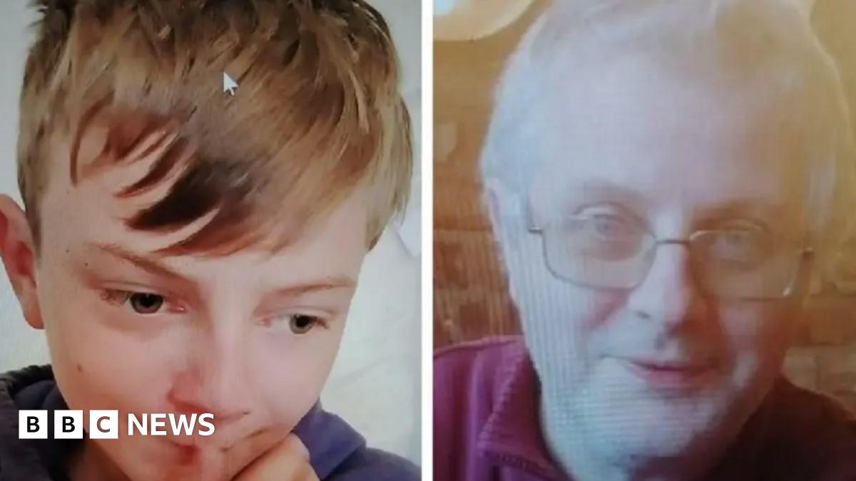A young boy with blonde hair looking down and a blurred photo of a man with white hair and glasses