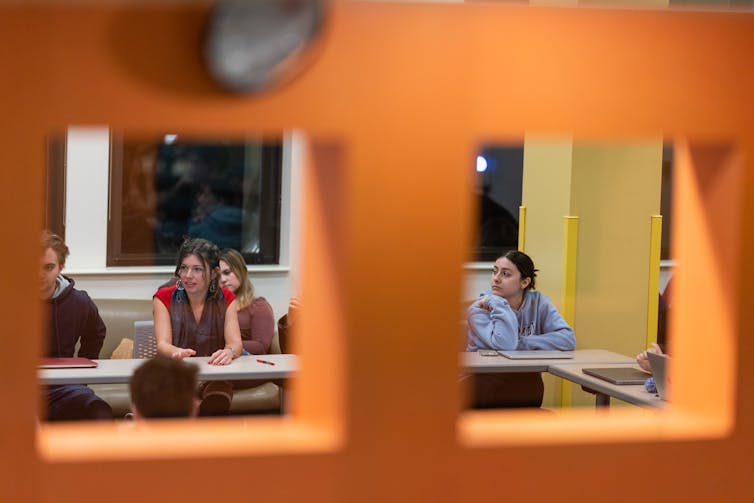 A college student in discussion in a classroom