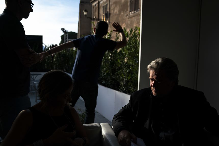 Former White House Chief Strategist Steve Bannon talks with Giorgia Meloni, leader of the Brothers of Italy, before speaking at Atreju 2018, a conference of right wing activists, as aids block cameras from viewing through the bushes behind on September 22, 2018 in Rome, Italy. Meloni, known for her conservative ideals, is now prime minister of Italy.