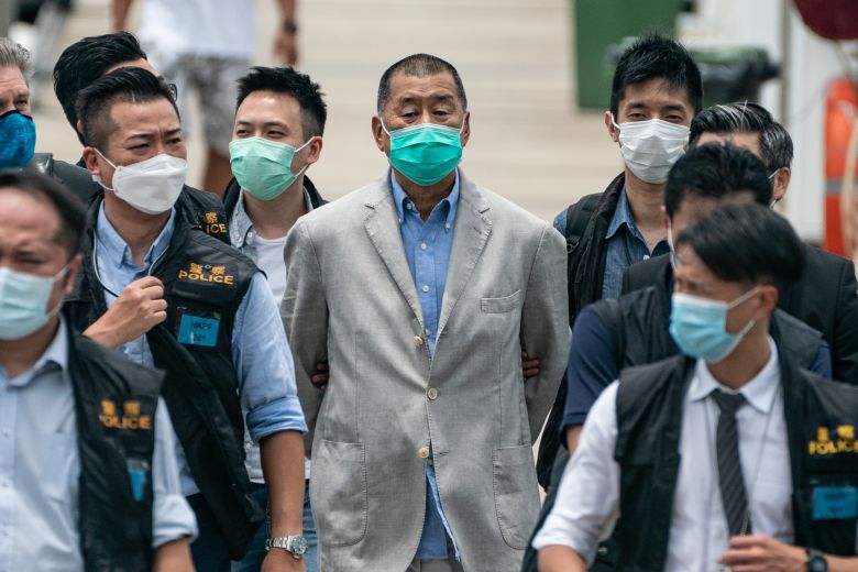 Apple Daily founder Jimmy Lai is escorted by the police for evidence collection as part of the ongoing investigations in Hong Kong on August 11, 2020.