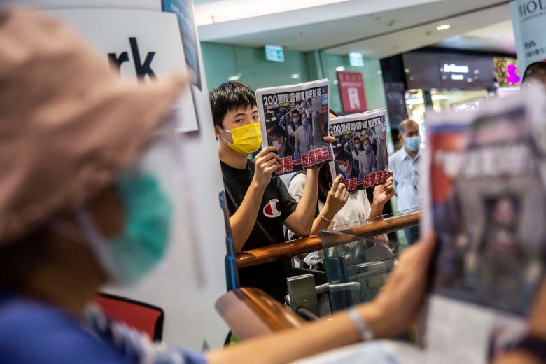 People hold up copies of the Apple Daily as they protest for press freedom after authorities conducted a search of the newspaper's headquarters in Hong Kong in August, 2020.