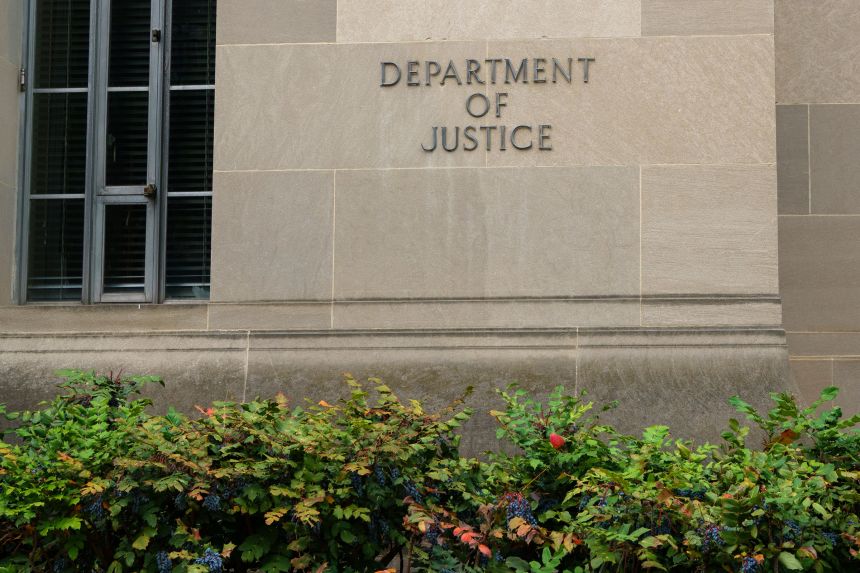 A sign is displayed outside of the Robert F. Kennedy Department of Justice building in Washington, DC, on June 1, 2025.