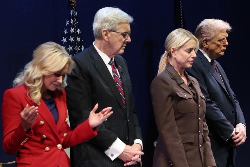 President Donald Trump bows his head in prayer with pastor Paula White, left, Texas Lt. Gov. Dan Patrick and Attorney General Pam Bondi at the Museum of the Bible on September 8, 2025. Trump addressed the White House Religious Liberties Commission during the event.