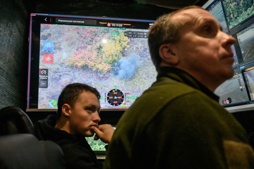 Ukrainian soldiers at a drone command center watching a fatal drone strike on a Russian soldier in eastern Ukraine, on October 7, 2025.