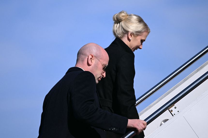 White House Deputy Chief of Staff Stephen Miller, left, and White House assistant to the President Natalie Harp board Air Force One at Joint Base Andrews, Maryland, on January 27.