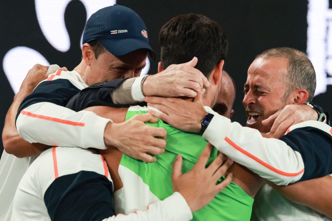 Carlos Alcaraz celebrates with his team after his historic victory in Melbourne.
