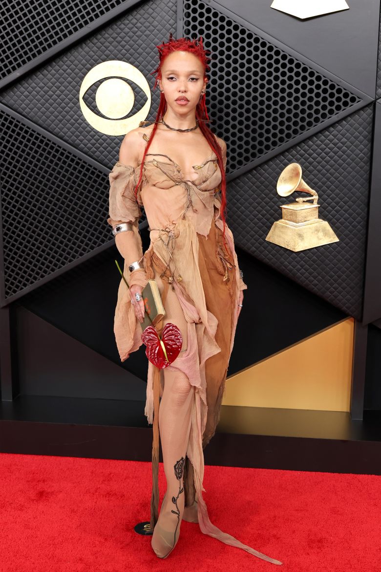FKA Twigs arrived early in a custom Paolo Carzana dress dyed with copper.