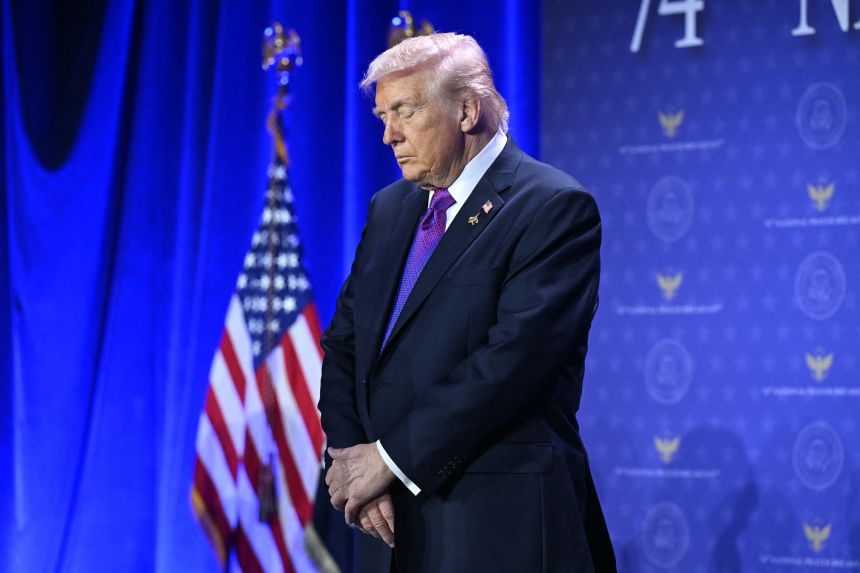 President Donald Trump bows his head in prayer during the National Prayer Breakfast in Washington, DC, on February 5.