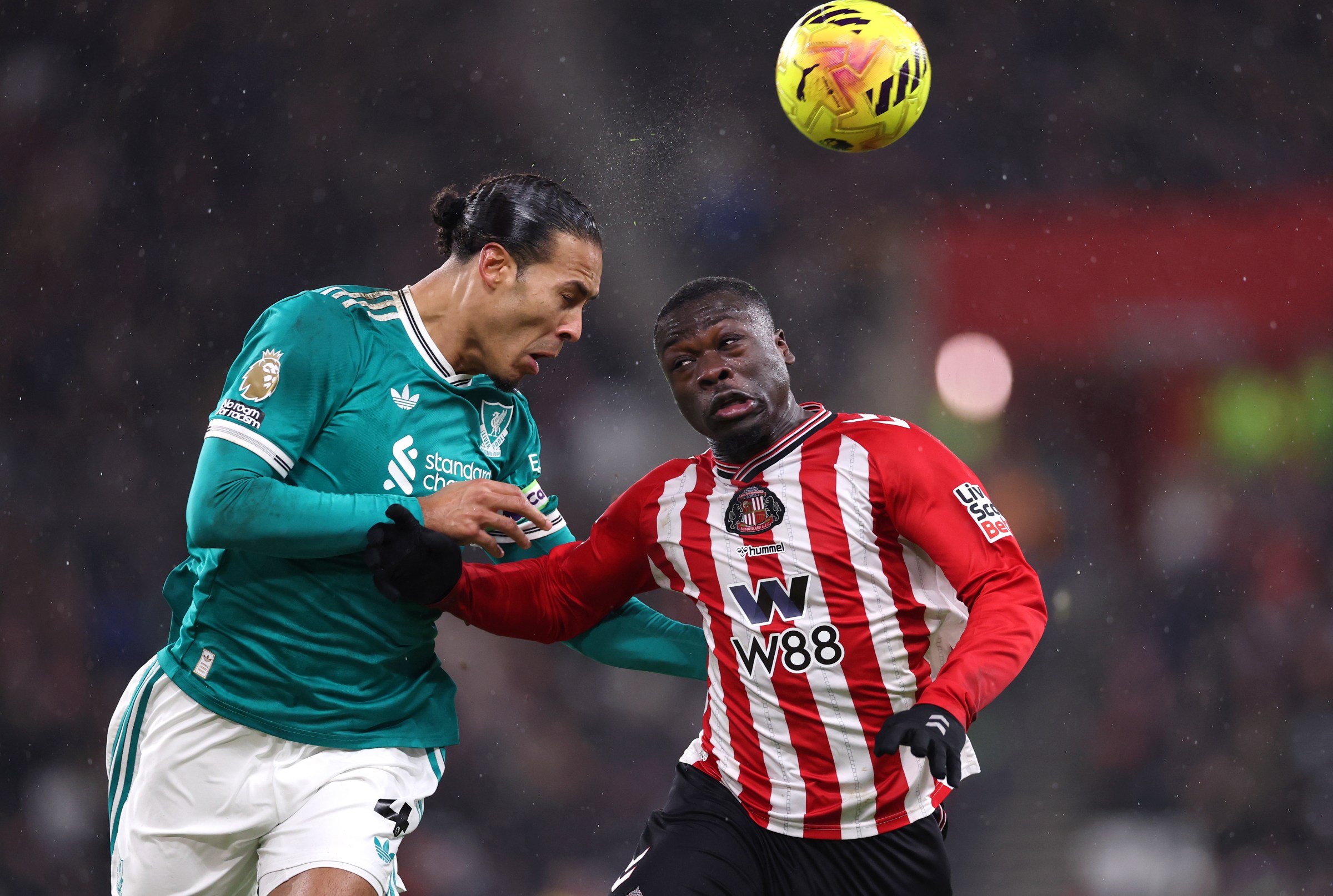 SUNDERLAND, ENGLAND - FEBRUARY 11: Virgil van Dijk of Liverpool wins a heading duel with Brian Brobbe of Sunderland during the Premier League match between Sunderland and Liverpool at Stadium of Light on February 11, 2026 in Sunderland, England. (Photo by Stu Forster/Getty Images)