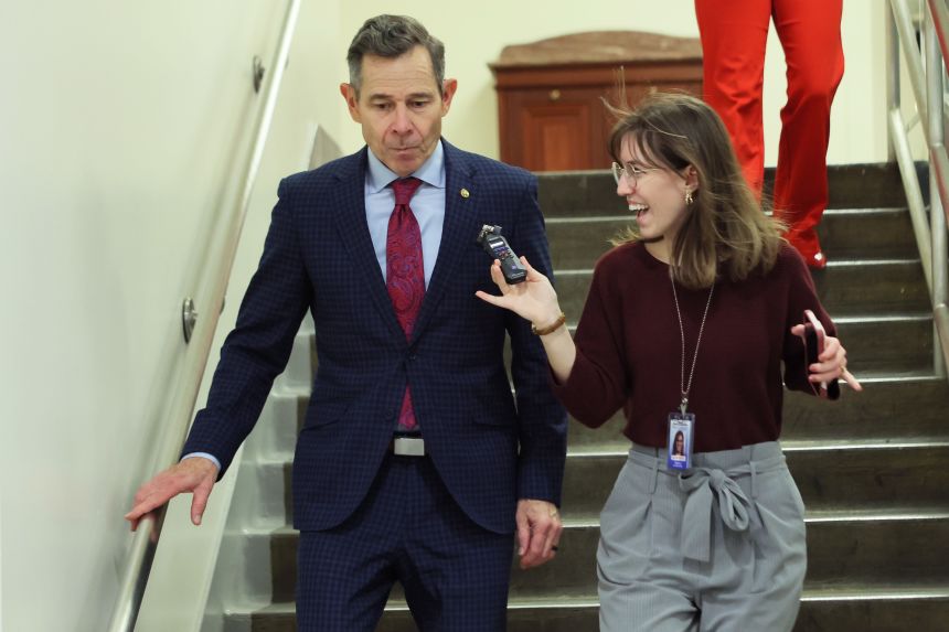 Sen. John Curtis speaks with reporters as he walks through the basement of the US Capitol on Thursday, February 12, in Washington, DC.