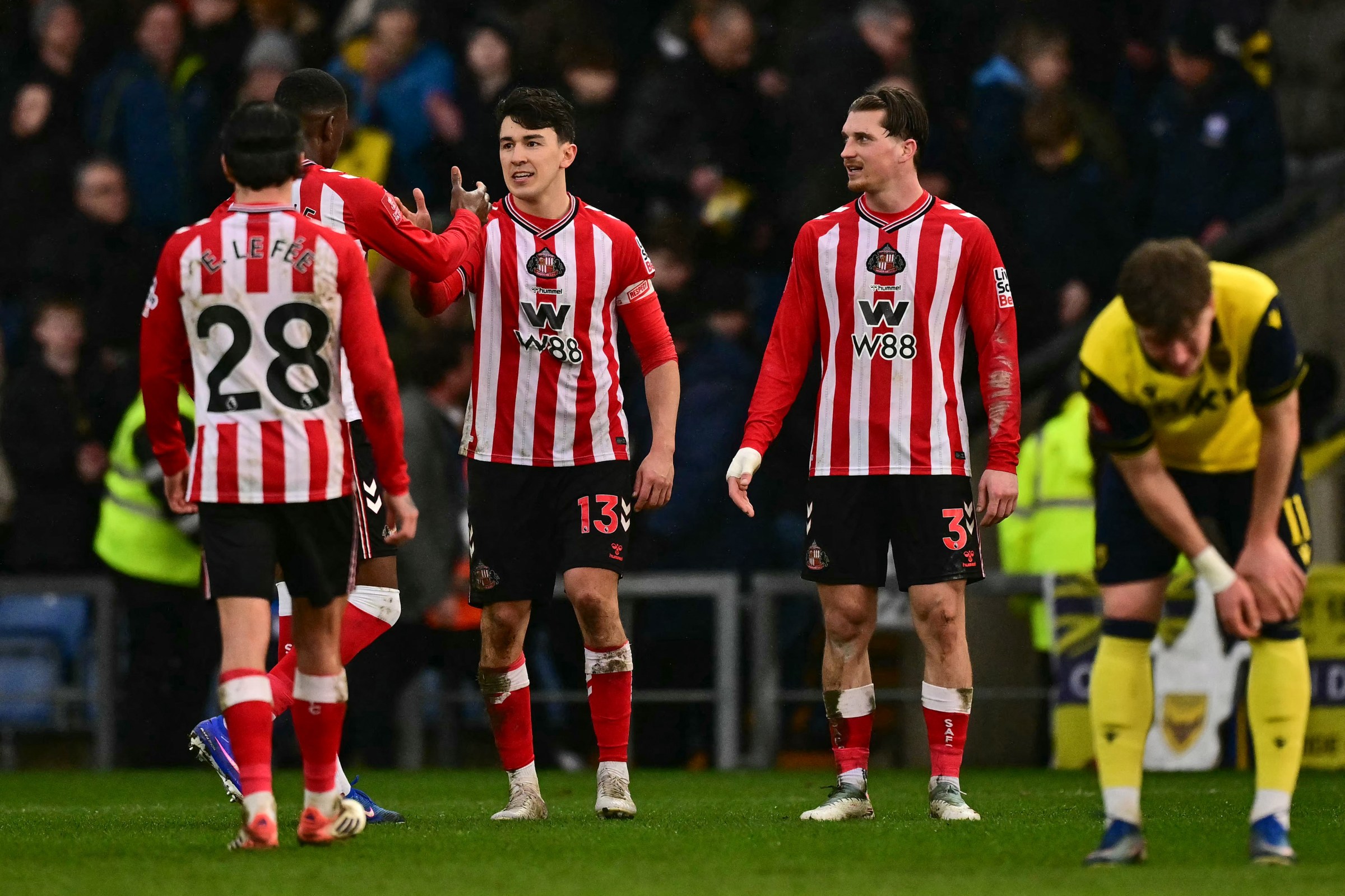 Sunderland’s French midfielder #28 Enzo Le Fee (L), Sunderland’s English midfielder #13 Luke O’Nien (C) and Sunderland’s English defender #03 Dennis Cirkin (2nd R) react at the end of their victory in the English FA Cup fourth round football match between Oxford United and Sunderland at the Kassam Stadium in Oxford, west of London, on February 15, 2026. (Photo by Ben STANSALL / AFP via Getty Images) / RESTRICTED TO EDITORIAL USE. No use with unauthorized audio, video, data, fixture lists, club/league logos or ‘live’ services. Online in-match use limited to 120 images. An additional 40 images may be used in extra time. No video emulation. Social media in-match use limited to 120 images. An additional 40 images may be used in extra time. No use in betting publications, games or single club/league/player publications. /