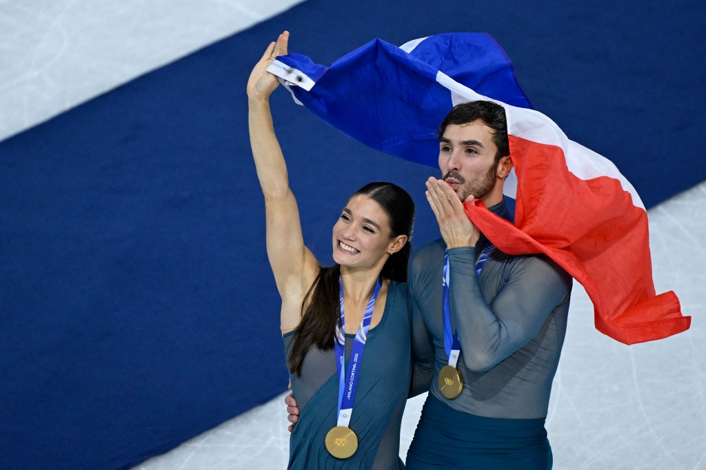 Gold medalists France's Laurence Fournier Beaudry and Guillaume Cizeron pose after the ice dancing free dance final during the Olympics on Feb. 11, 2026.