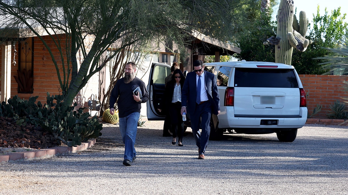 Law enforcement officers on the grounds of Annie Guthrie's property in Tucson.