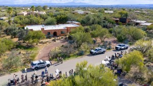 In an aerial view, law enforcement and news broadcasters are stationed outside of Nancy Guthrie's residence on February 10, 2026 in Tucson, Arizona