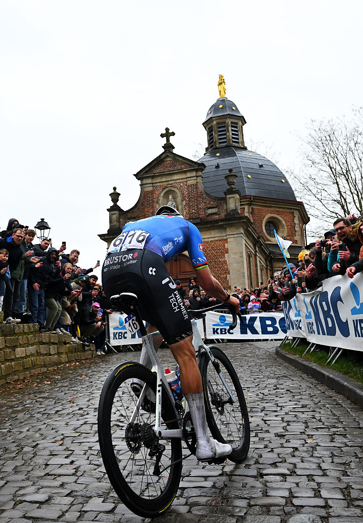 NIVONE, BELGIUM - FEBRUARY 28: Race winner Mathieu van der Poel of Netherlands and Team Alpecin-Premier Tech competes passing through the Muur - Kapelmuur cobblestones sector while fans cheer during the 21st Omloop Het Nieuwsblad 2026, Men&amp;apos;s Elite a 207.2km one day race from Ghent to Ninove / #UCIWT / on February 28, 2026 in Ninove, Belgium. (Photo by Tim de Waele/Getty Images)