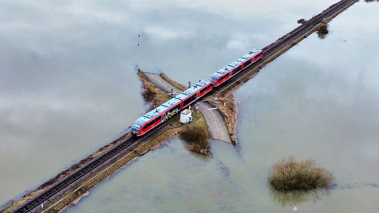 A train travels through an area near Frankfurt surrounded by flooding. Pic: AP