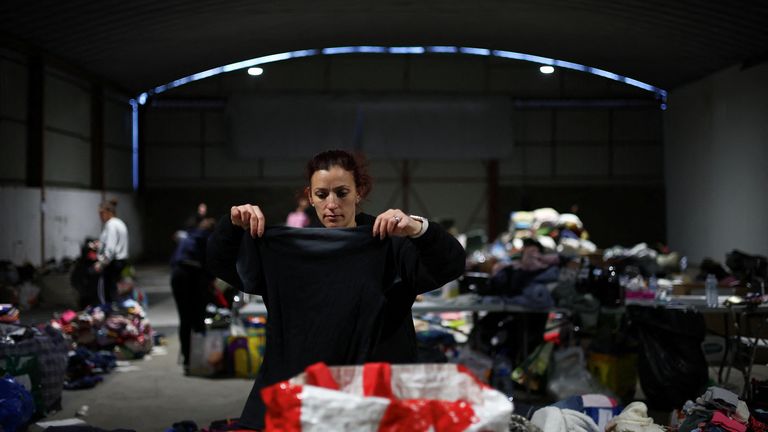 A volunteer gathers and selects donations for people forced to flee from their homes. Pic: Reuters