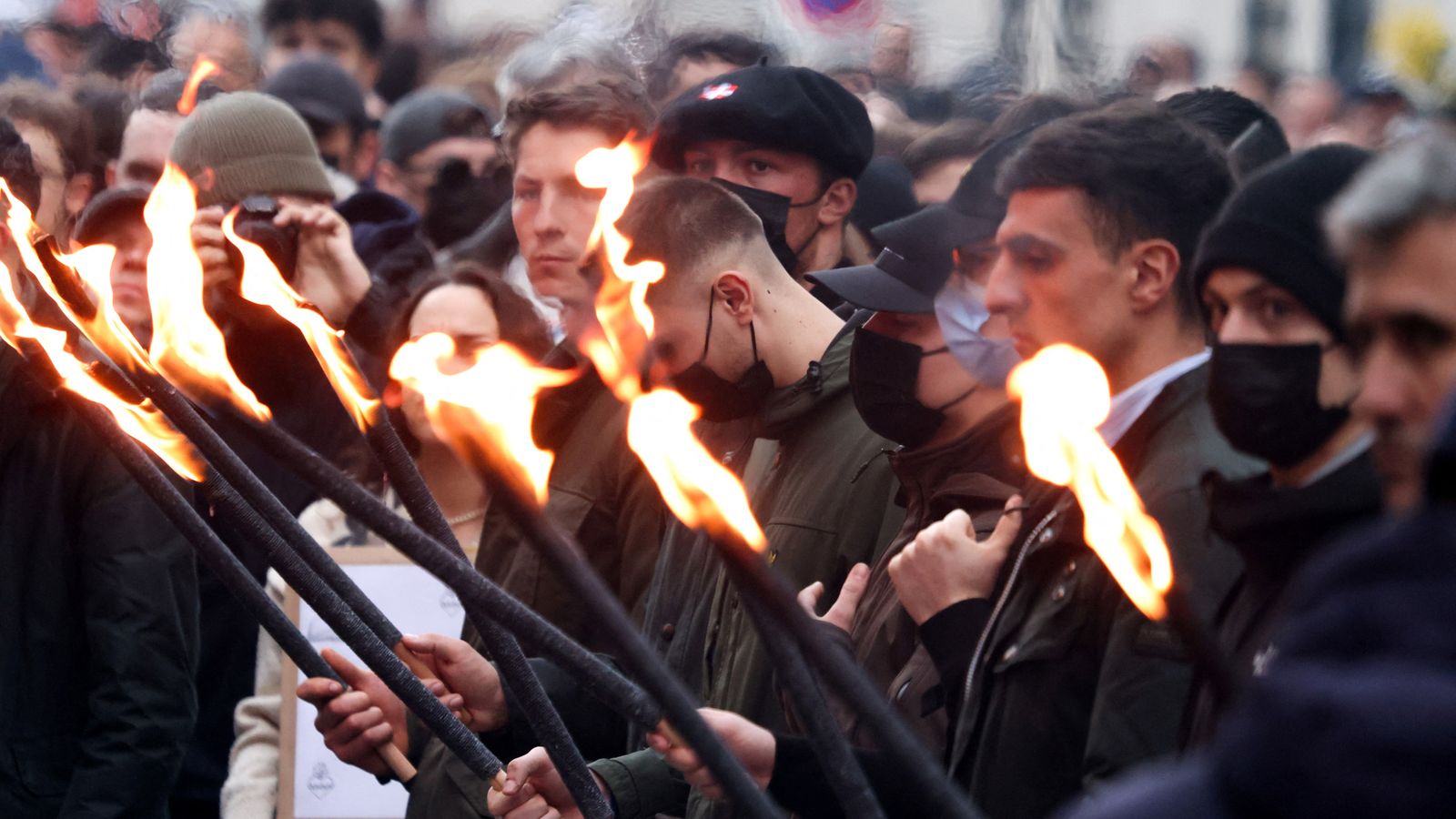 People holding lit torches during the march. Pic: Reuters