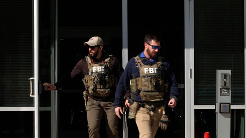 FBI agents exit the Fulton County Elections Hub and Operation Center while serving a warrant on January 28 near metro Atlanta.