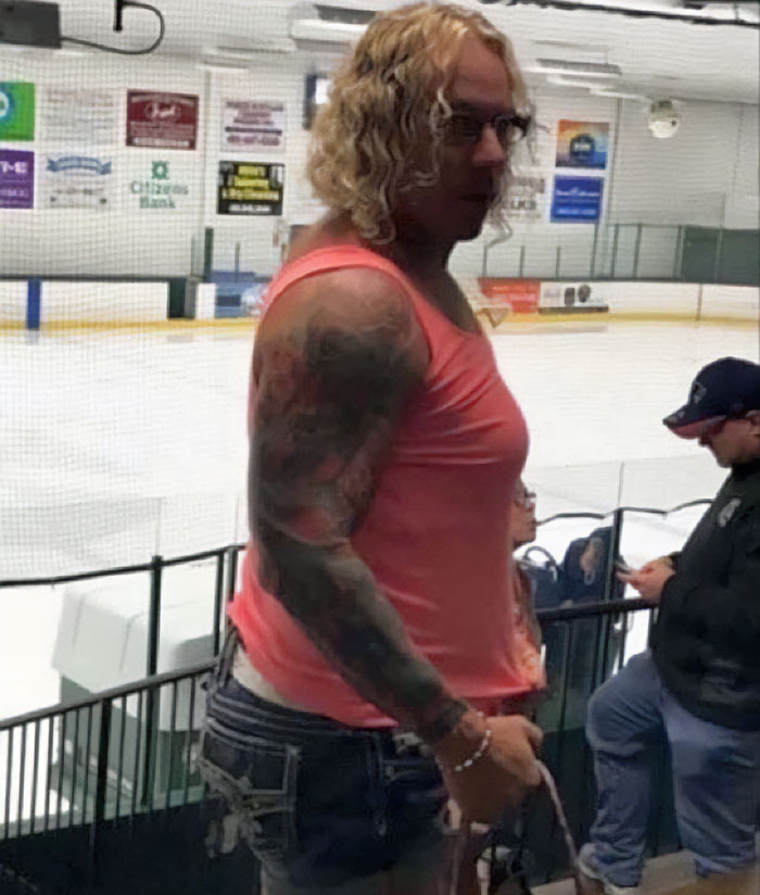 Person with tattoos and glasses standing inside an ice rink, related to police discovery about ice rink attacker’s family. Person with tattoos and glasses standing inside an ice rink, related to police discovery about ice rink attacker’s family.
