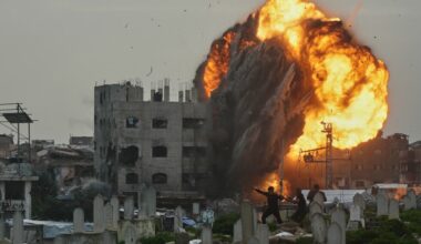 Photos show an Israeli airstrike in detail while men take cover in a graveyard