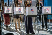 Voters silhouetted by early morning sunlight in Clarksburg, Maryland.