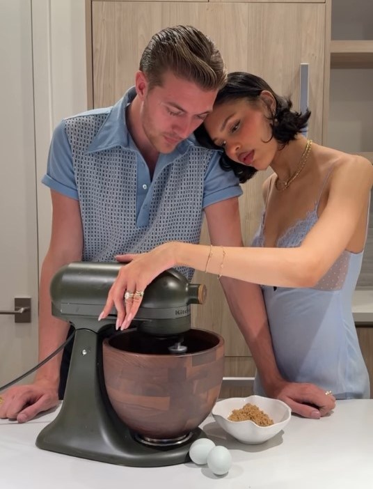 Lucky Blue Smith and Nara Smith in a kitchen with a stand mixer, eggs, and brown sugar.
