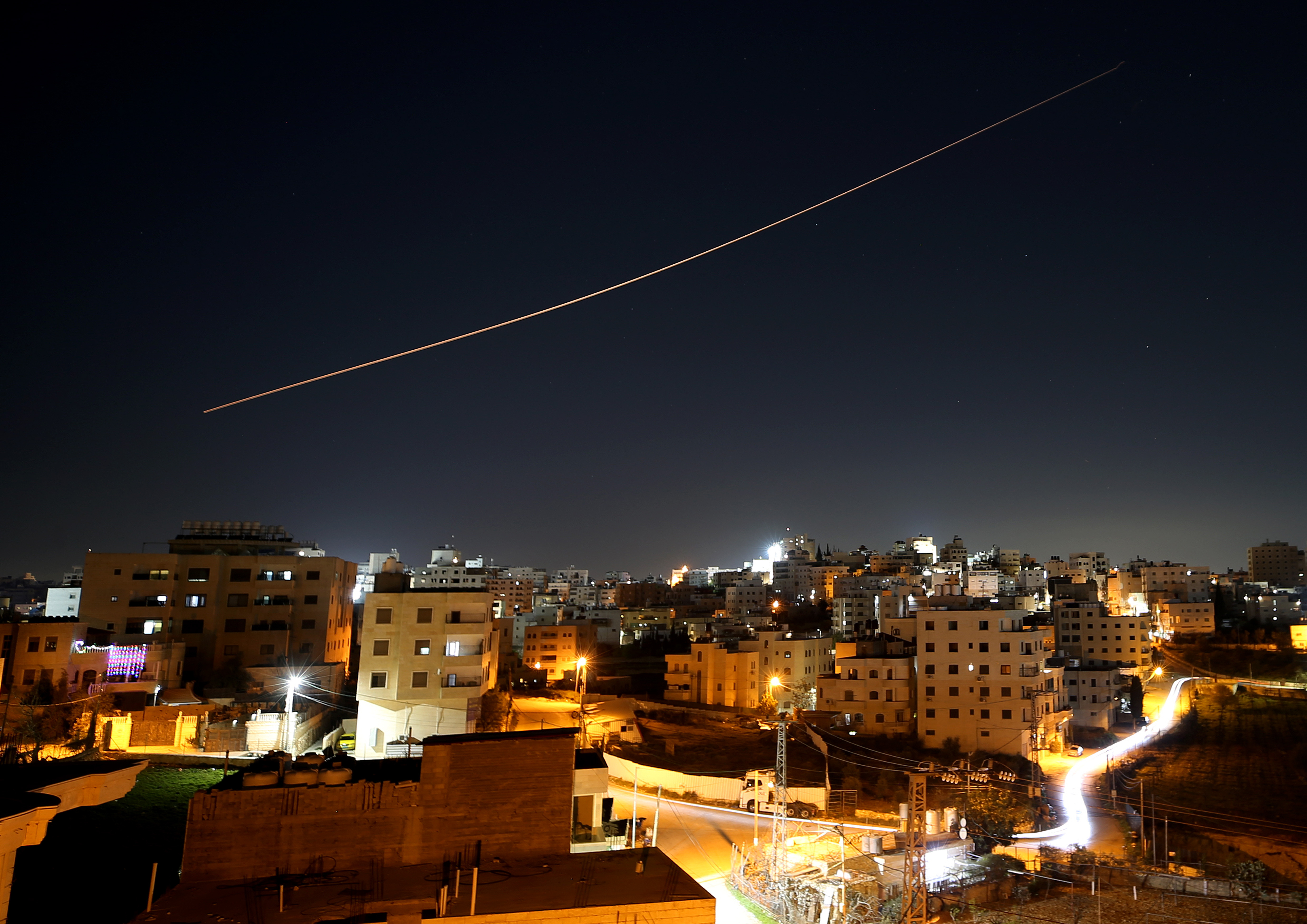 Missiles launched from are seen streaking across the night sky over Hebron in the West Bank on Wednesday